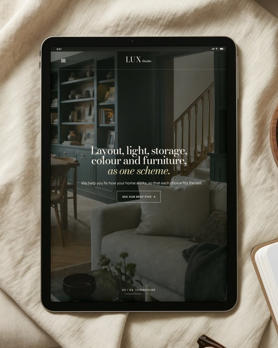 The LUX Studio homepage on an iPad lying on linen