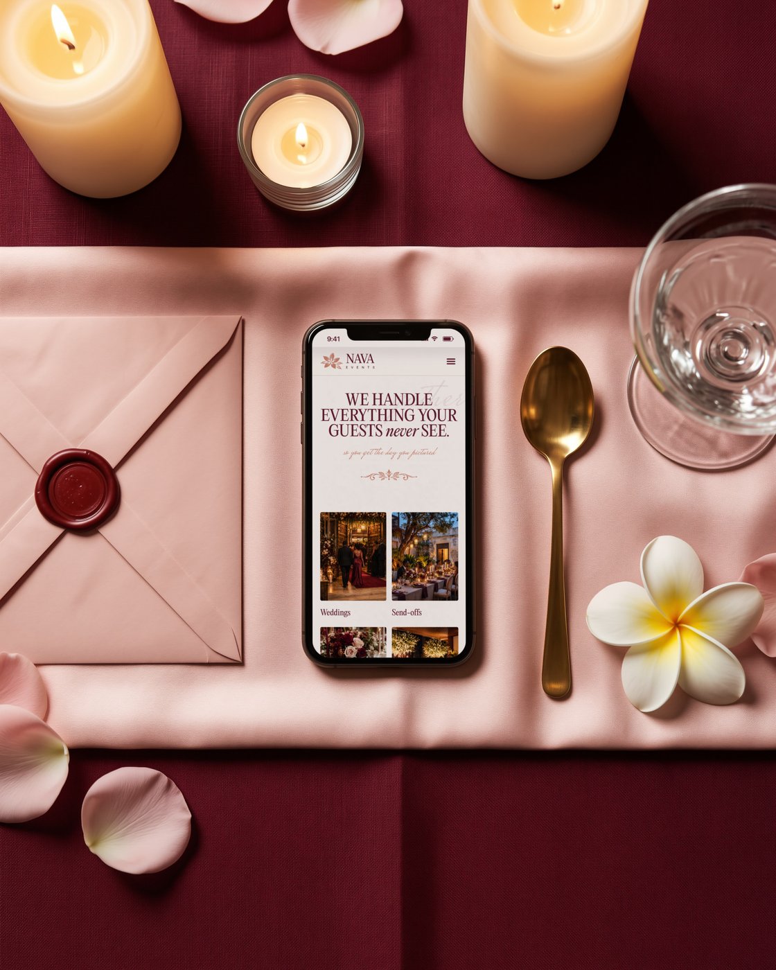 The NAVA Events website on a phone on a blush silk runner at a candlelit table