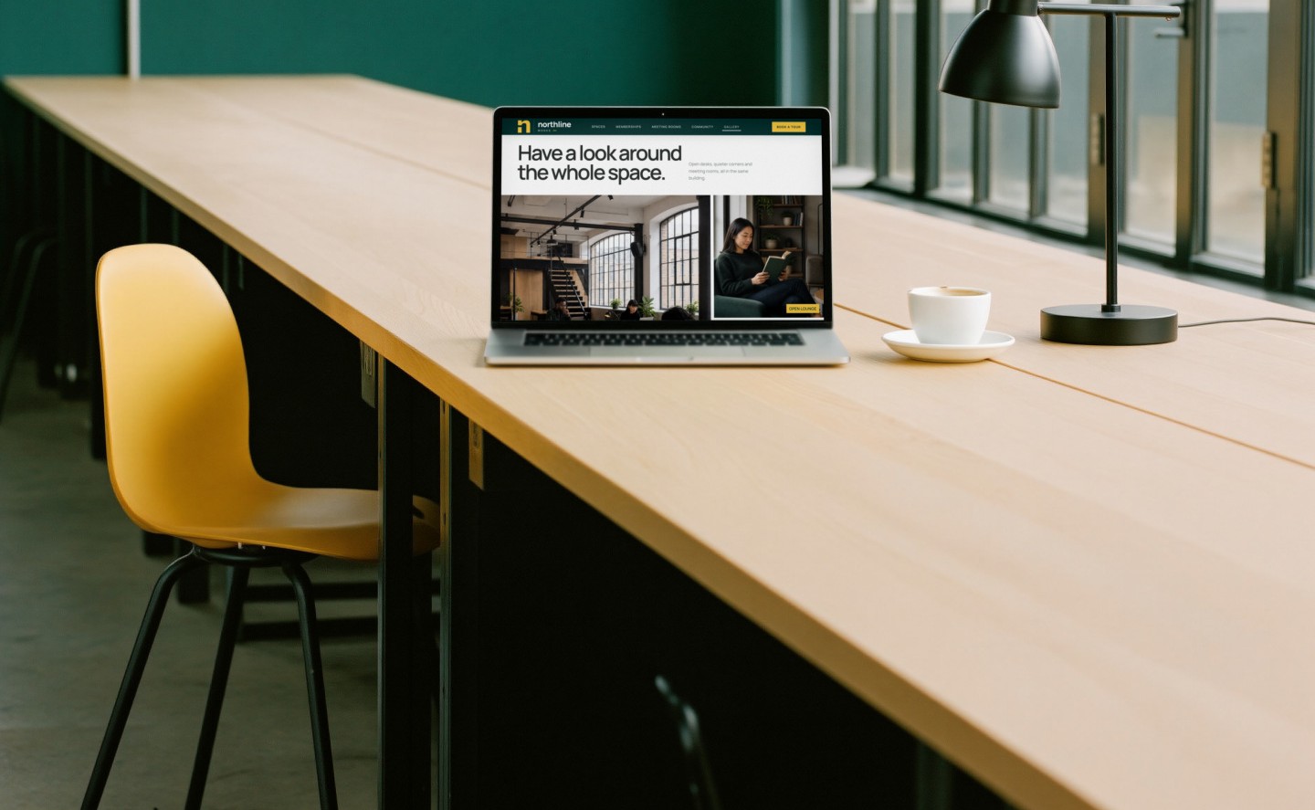 Northline Works on a laptop at a long oak desk