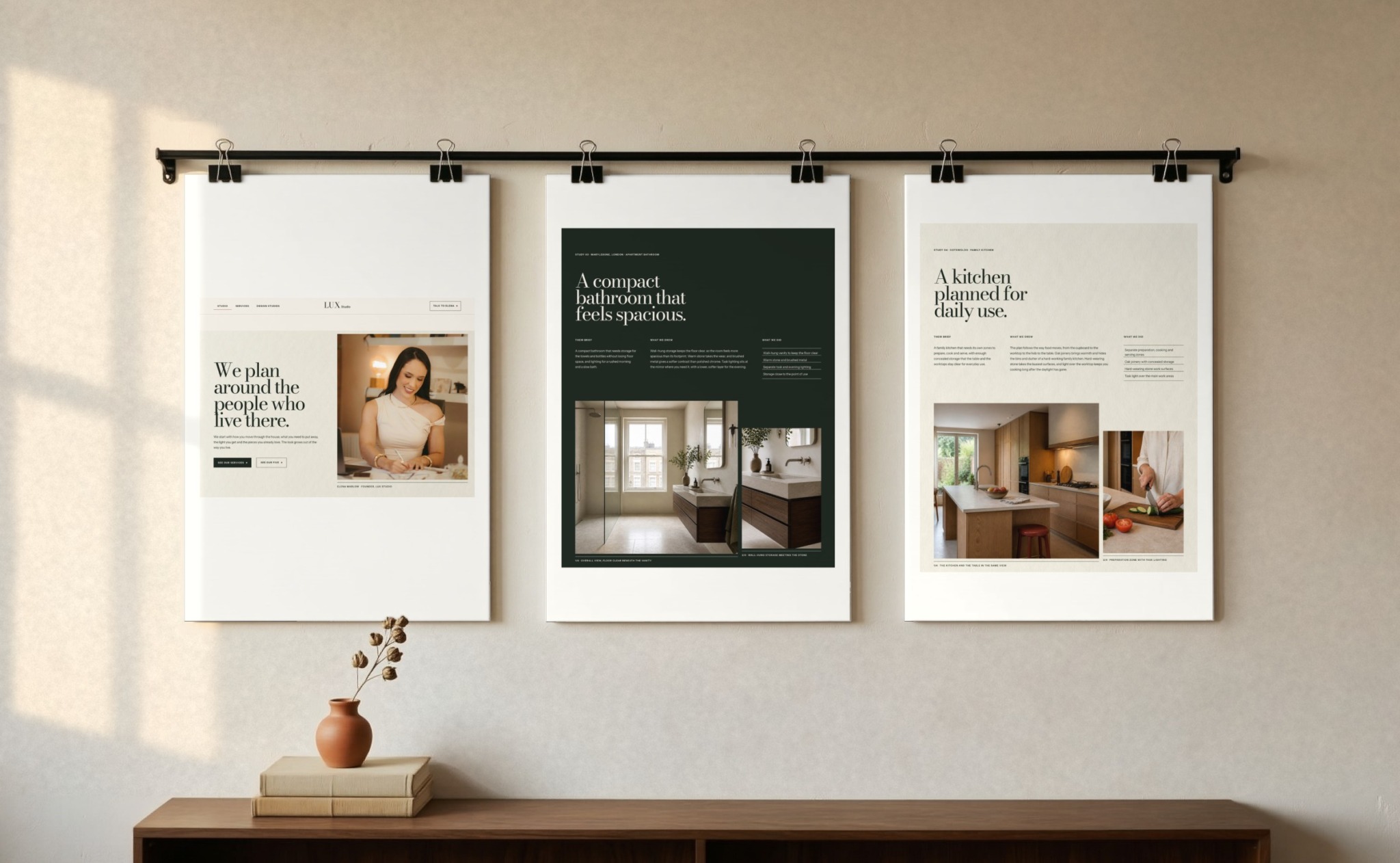 Three LUX Studio pages pinned on a plaster wall