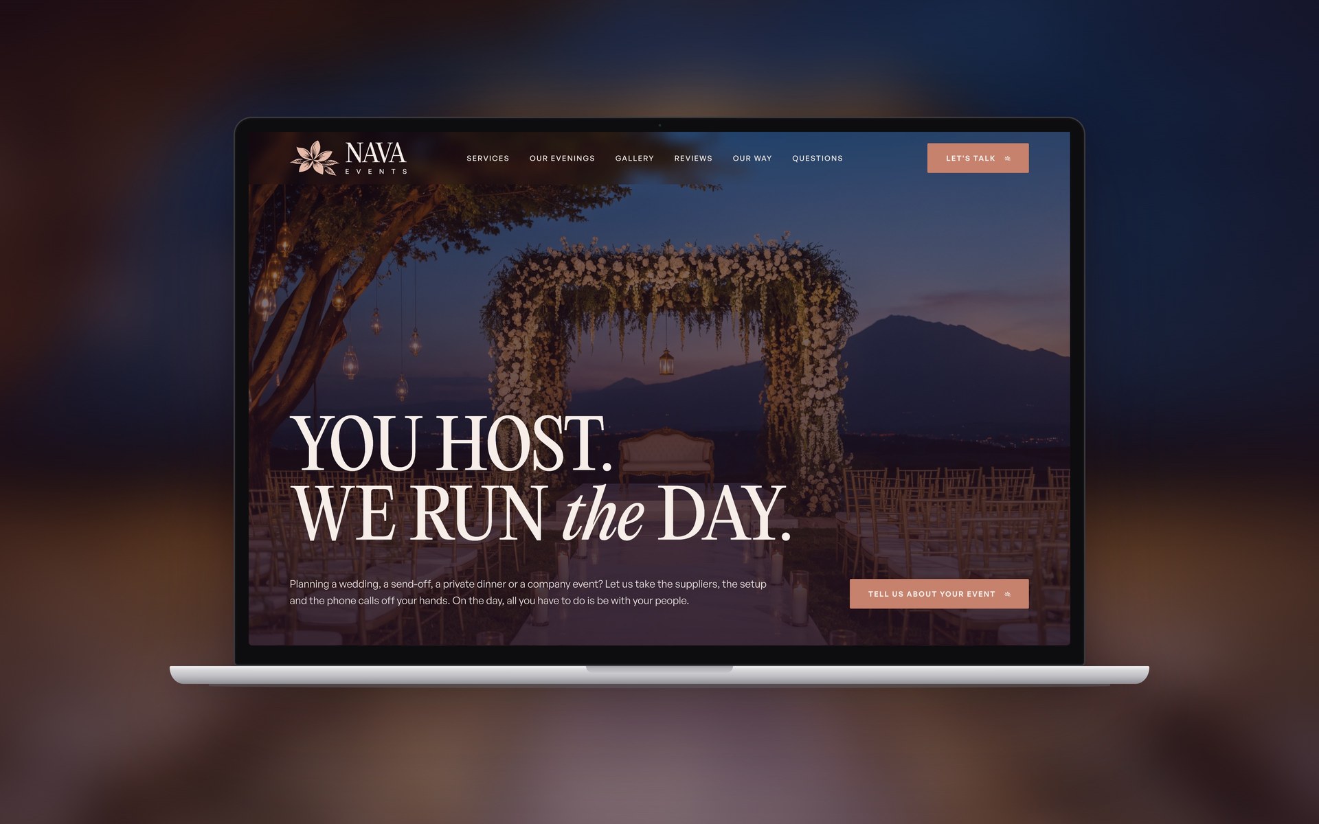 The NAVA Events website on a laptop over its own blurred first screen