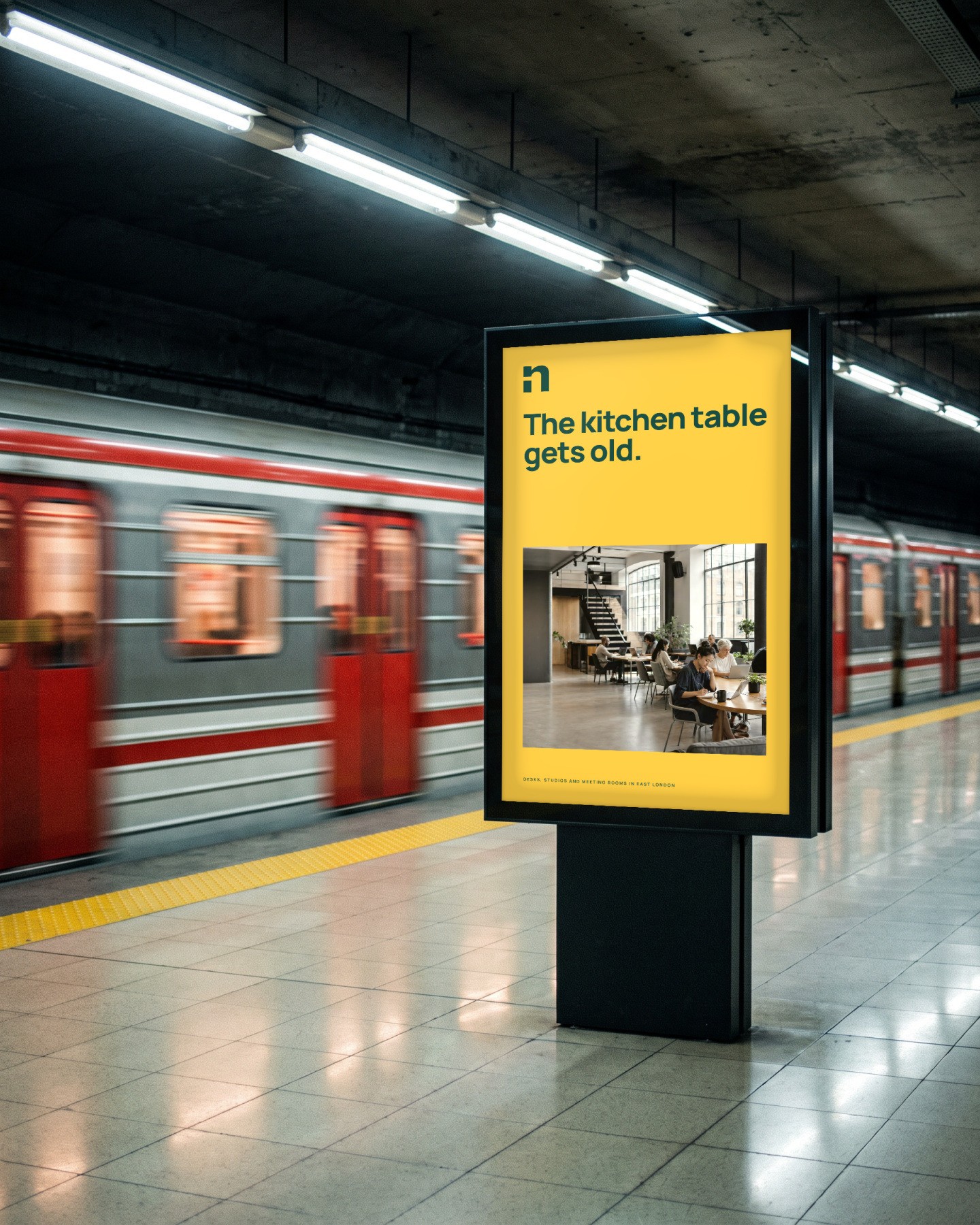 A Northline lightbox on a train platform: The kitchen table gets old
