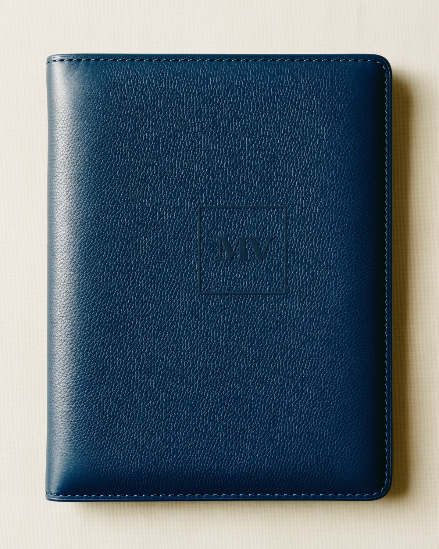 Morrow & Vale: the MV monogram debossed in a navy leather folio